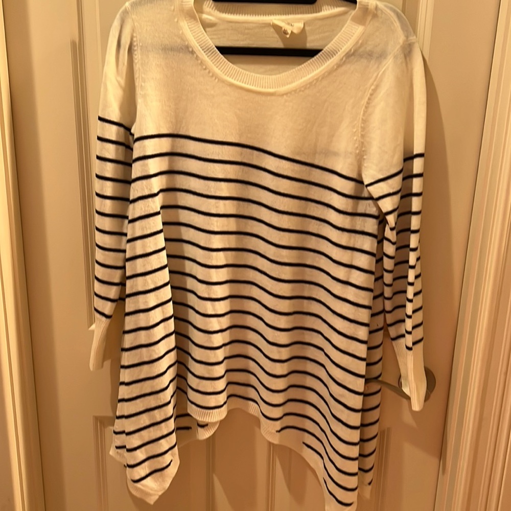 Flowy navy and off white sweater with angled hips.